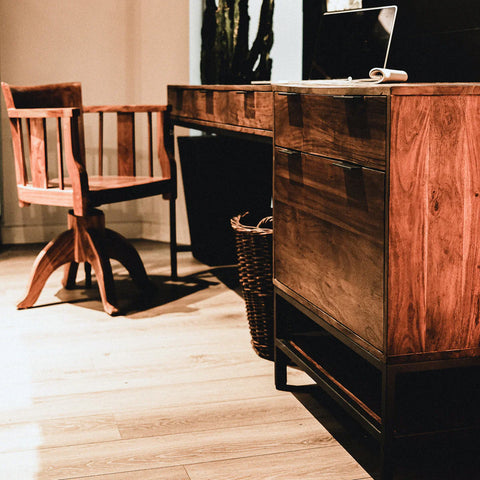 Solid acacia wood 3 piece desk in honey brown finish with industrial black metal frame. Showing only one filing cabinet in office setting.