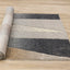 Cora Rug - Geometric Black Brown roll on floor