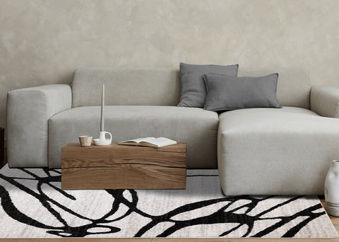 Eclipse Rug - Black Swirls in living room setting