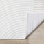 Hayden Rug - Light Cream Swirl corner flipped to show underside