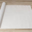 Hayden Rug - Light Cream Swirl roll on floor