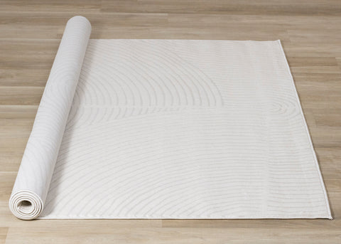 Hayden Rug - Light Cream Swirl roll on floor