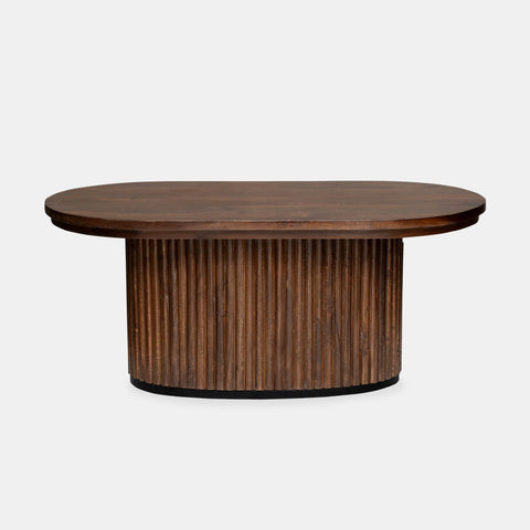 Solid mango wood oblong coffee table with repeating pattern ribbing base in brown finish.