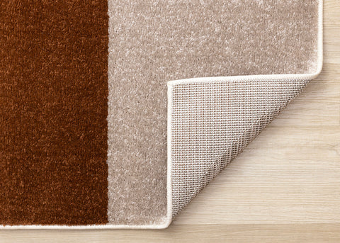 Malibu Rug - Curvy Geometric Taupe Oxblood corner flipped to show underside