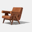 Caramel brown leather lounge chair with leather armrests and solid ash wood legs stained walnut.