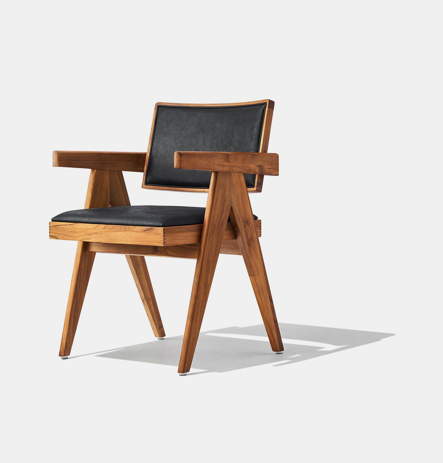 Solid ash wood dining chair stained in walnut with genuine black leather seat and back. 