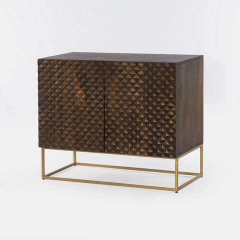 Dark brown mango wood sideboard with a CNC carved repeating pyramid pattern on the two doors. Brass finished iron legs & frame.