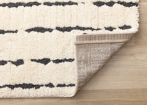 Talia Rug - Black Rain corner flipped to show underside