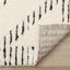 Talia Rug - Black Striped Diamond corner flipped to show underside