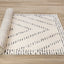 Talia Rug - Black Striped Diamond roll on floor
