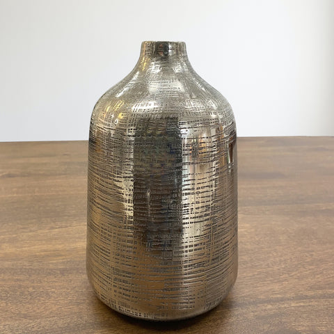 Aluminum bottle shaped vase in silver finish with small opening.