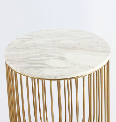 Top detail of side Table in white Carrara Marble sitting on a gold chromed stainless steel base resembling a bird-cage