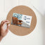 Man's hands at a desk holing an envelope and Qubik Furniture gift card worth a 250$ value.