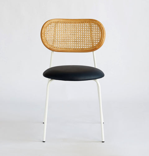 Bohemian chic Scandinavian style dining chair with black synthetic leather seat, natural rattan back framed in natural ash wood & white legs.