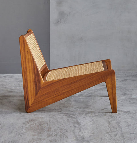 Lounge chair in walnut stained ash wood frame with natural rattan seat and back.